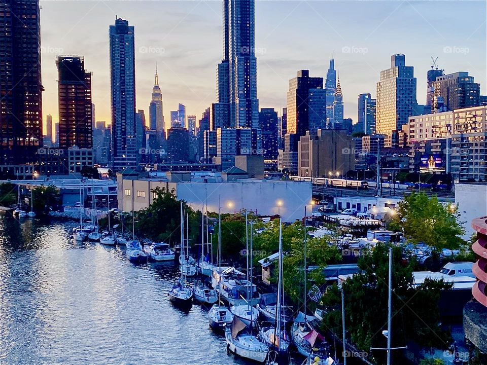 This is the view of “Newtown Creek” from the “Pulaski Bridge” on a balmy Indian summer evening in October 2023. You can see the boats that are tied to the shore as well as the combined skyline of LIC, Queens and “Manhattan”. Hypnotic Productions