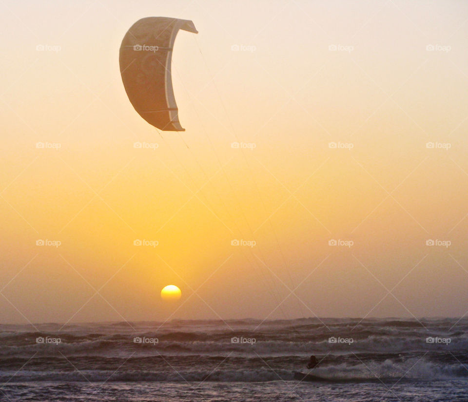 Kite surfing at sunset
