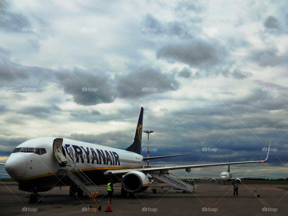 Plane at the airport after landing with amazing cloudy sky in the background