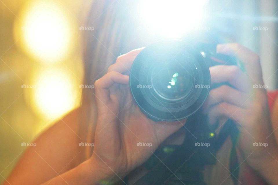 Blonde woman taking photo with Nikon Camera