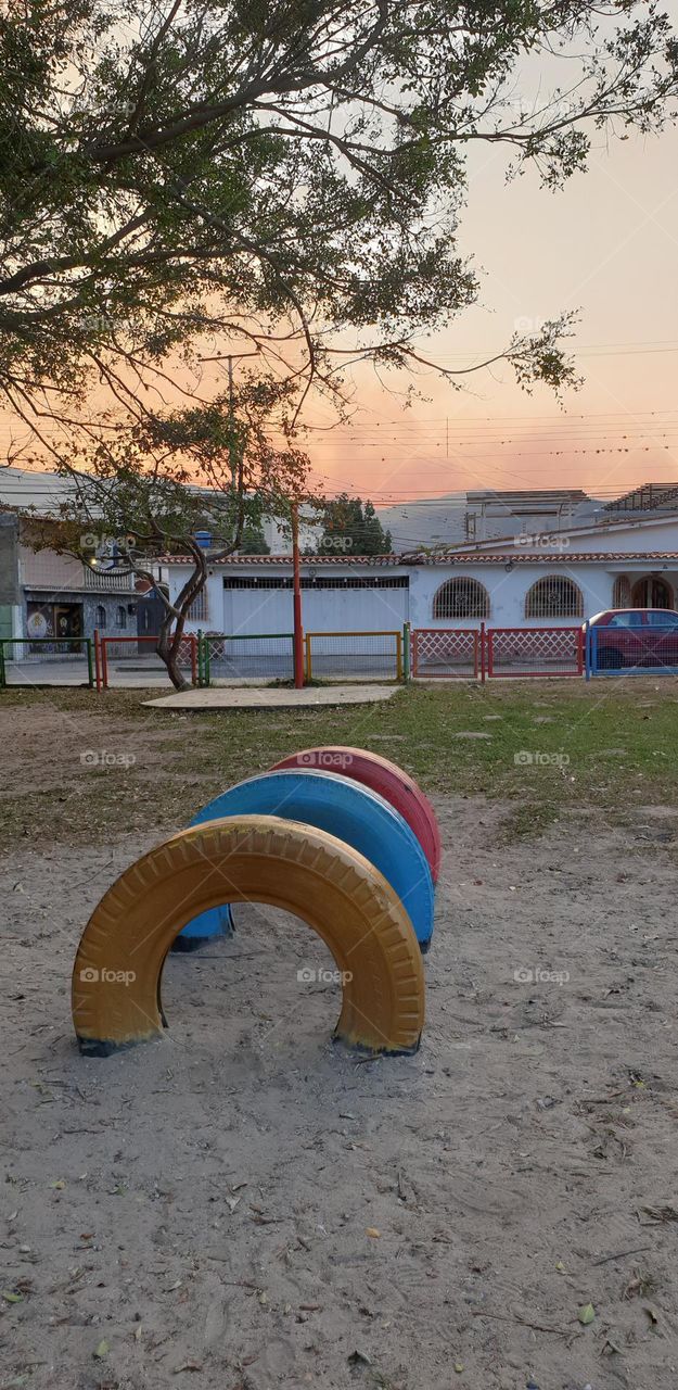 Playground, colored rubbers in the sand, circles, games for children.