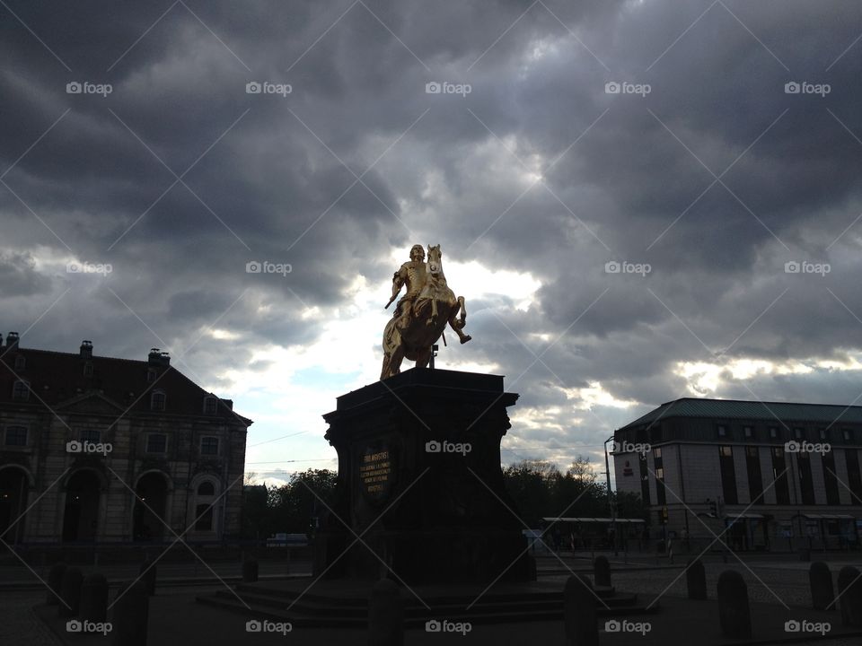 The statue in Dresden. This was a photo I took in Dresden, Germany as the sun was filtering through the clouds right behind this golden statue.
