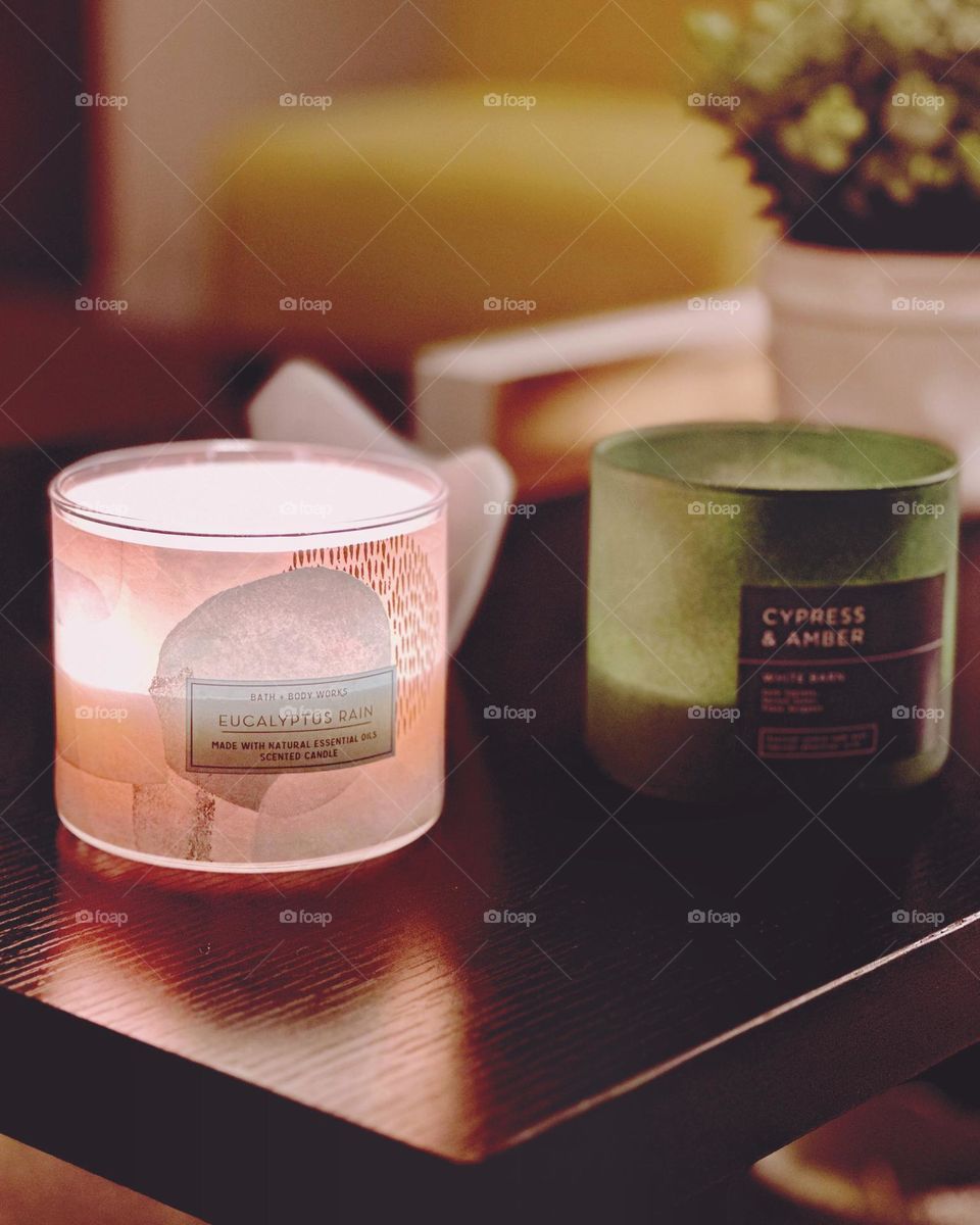 Two Bath and Body Works candles aglow.