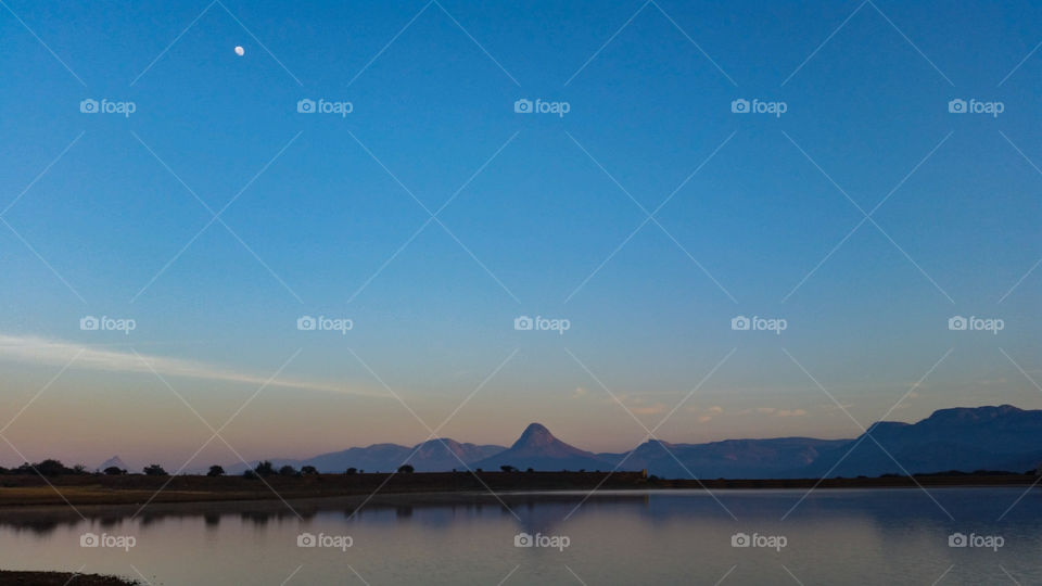 a lake with some mountains in the background