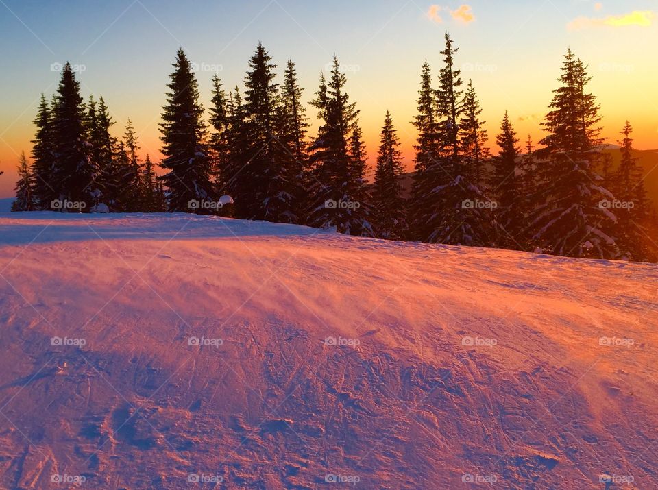 Scenic view of mountain in winter during sunset