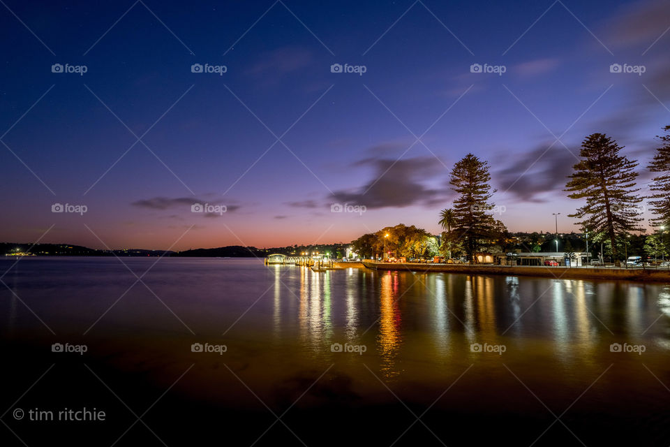 Rose Bay Ferry Wharf light reflecting off the harbour at dawn
