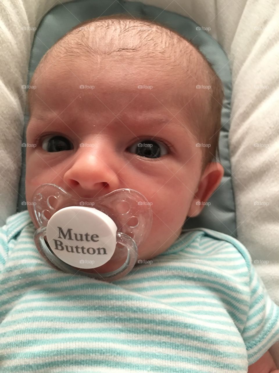 Infant with pacifier, funny.