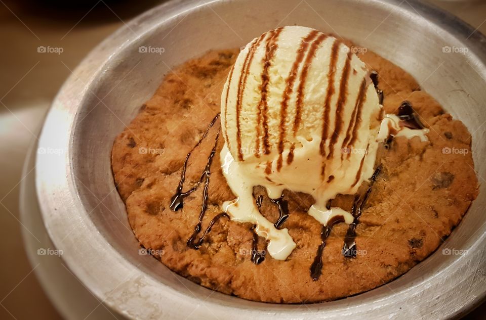 ice cream on a huge chocolate chip cookie