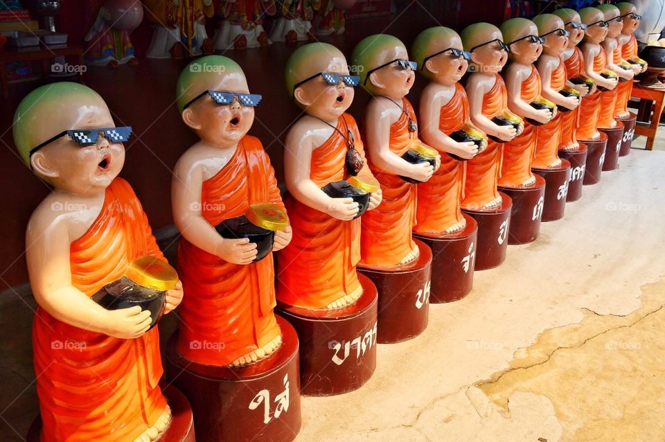 Monks statue wearing glasses in Thailand.