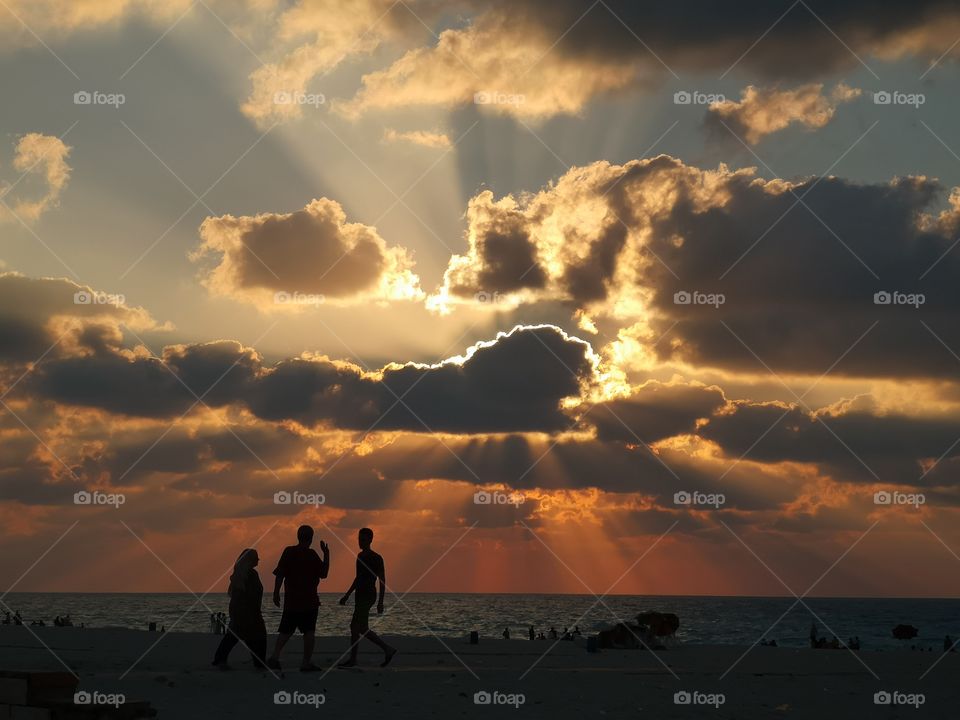 Family on the beach at sunset.