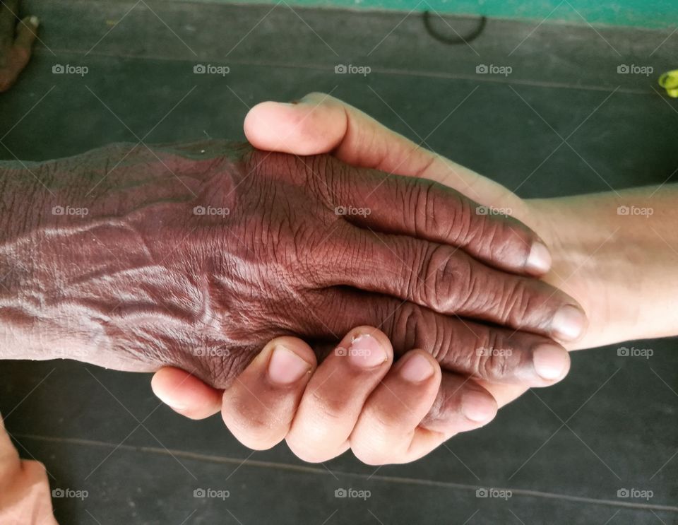 Granddaughter holding grandmother's hand