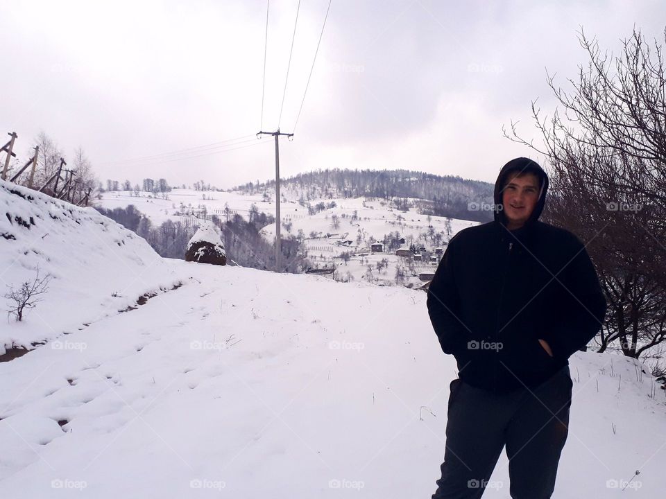 in a walk by the snow a photograph of my cousin, behind his back lies the village Kolići