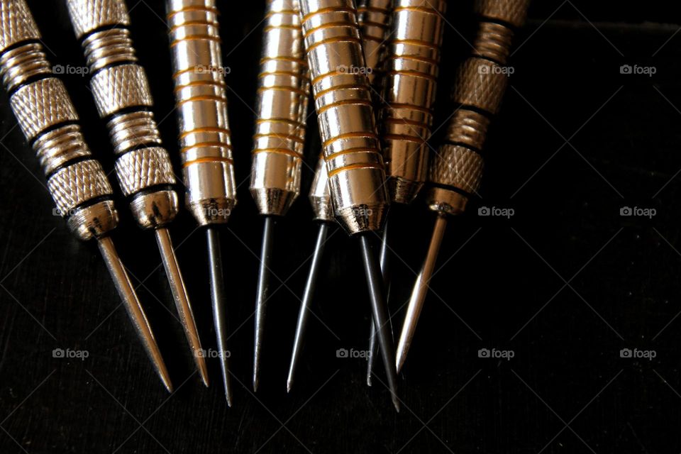 Close-up of darts lying on a table
