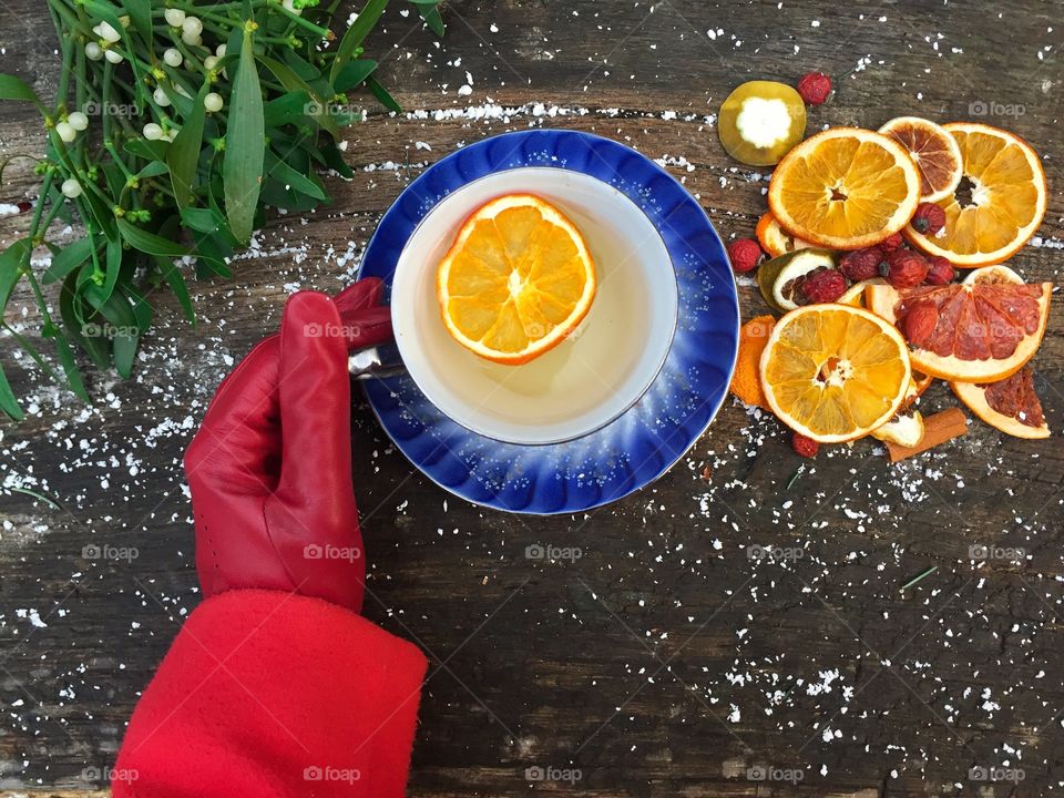 Person's hand holding tea cup