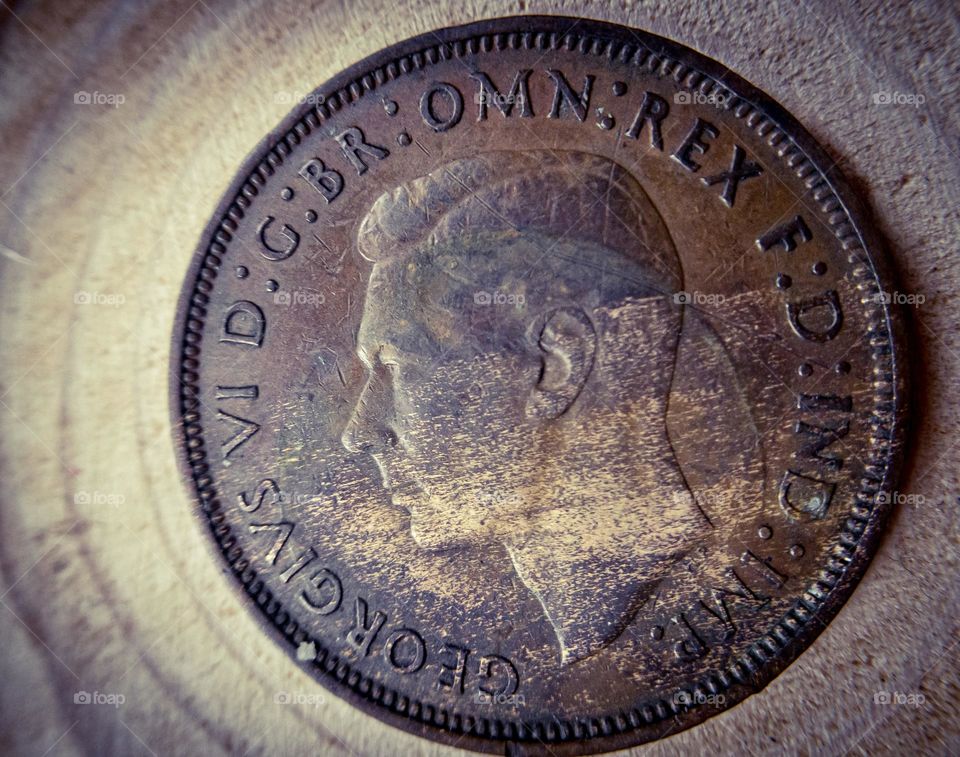 An old British penny bearing the head of King George VI 