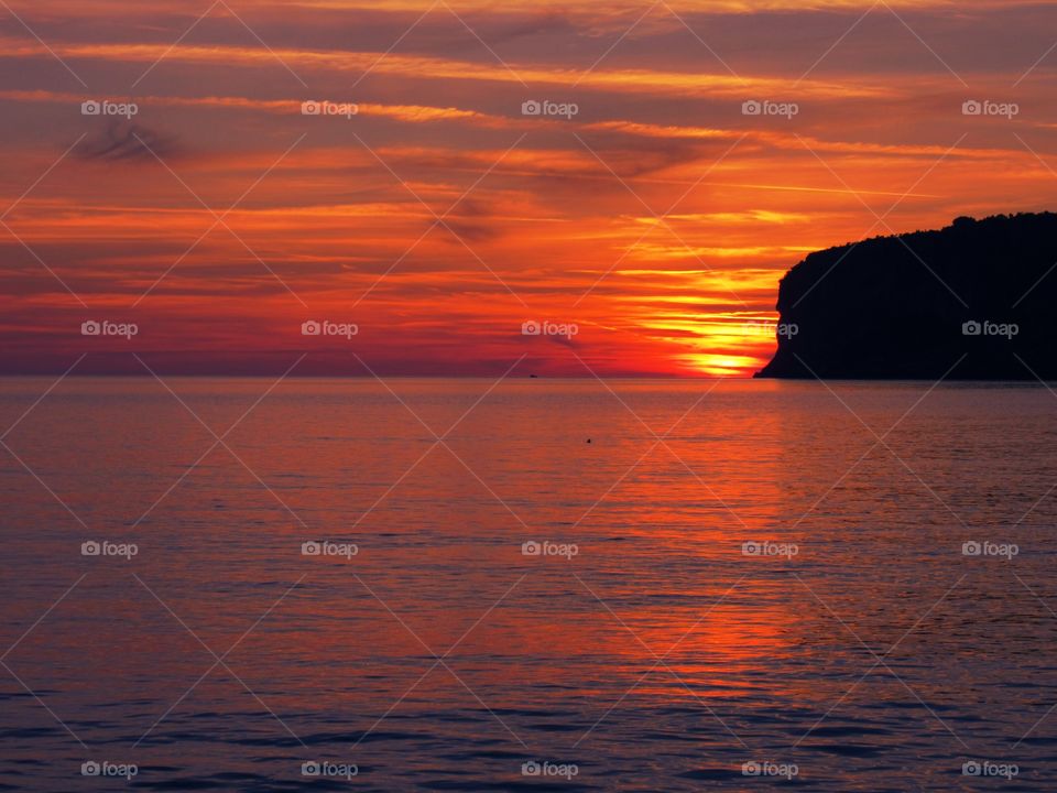 Sunset over Dino Islet  at Praia  (Italy ).
