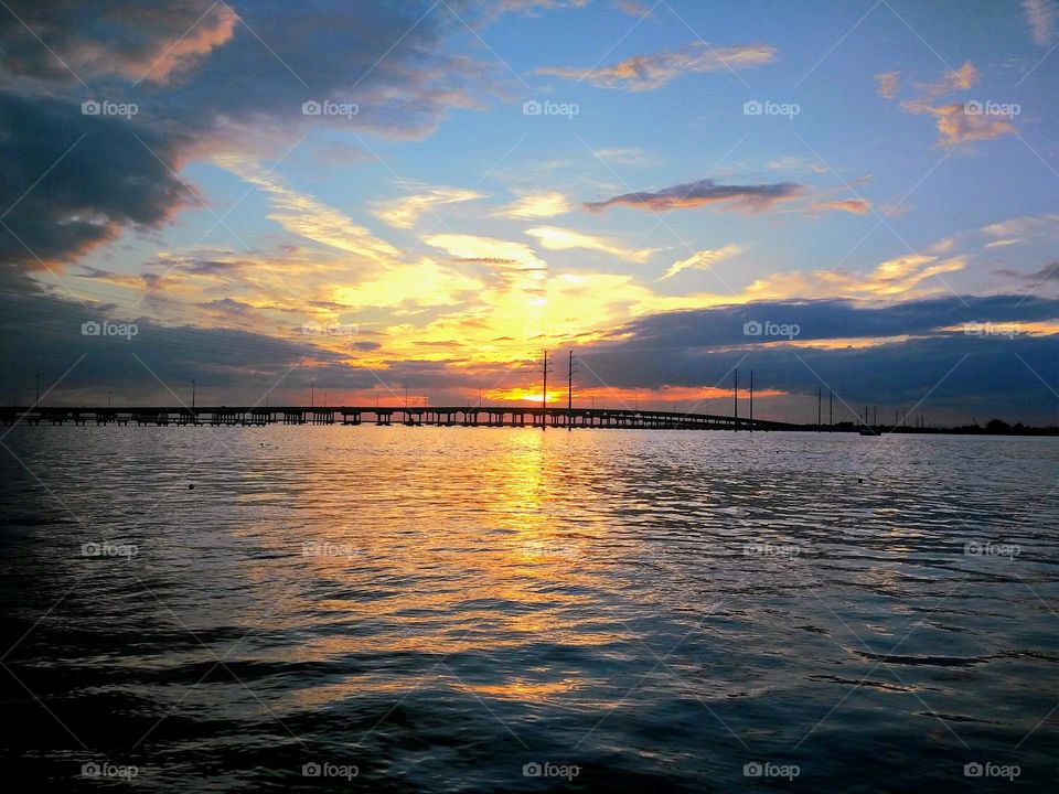 Beautiful summer evening on the water watching the sunset over the harbor bridge off the Gulf Coast of Florida.