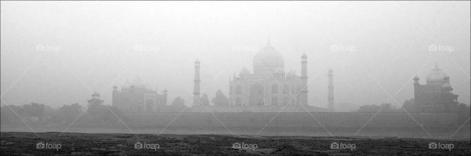 Taj Mahal by the banks of the Yamuna in the morning mist