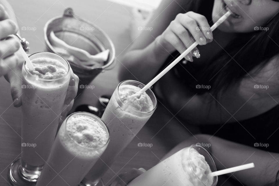 Girls having an oldstyle chat drinking milk shakes