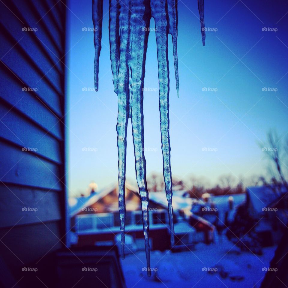 Icicle hanging from the eaves on a snowy day