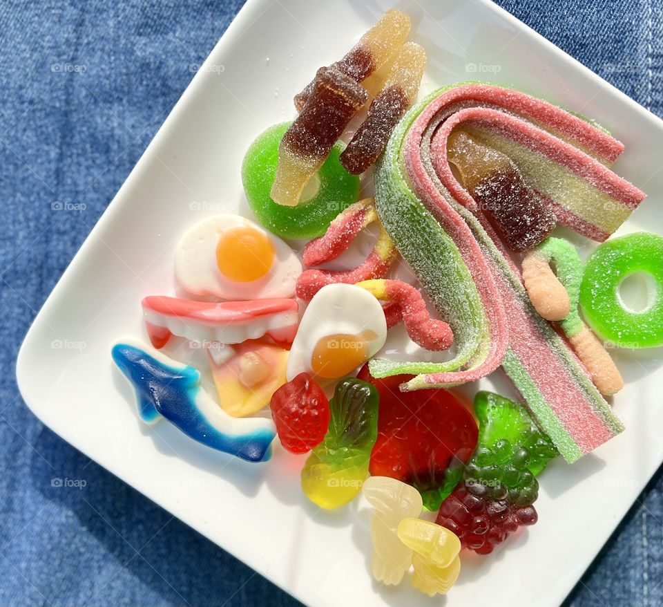 Assorted colourful rainbow fun gummies and sour strips