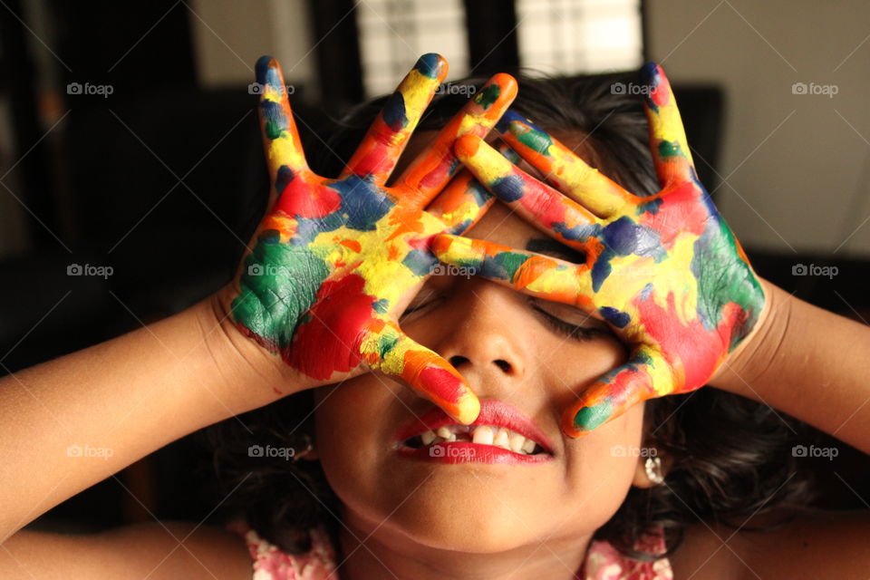 beautiful girl child with colourful hand palm