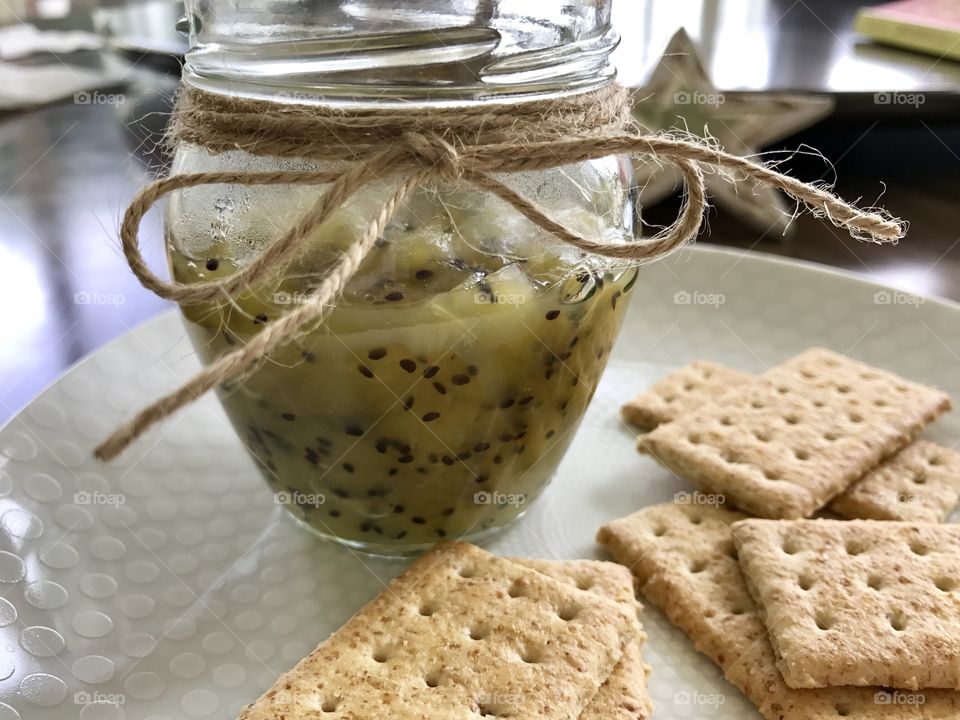 Kiwi jam and crackers on a plate