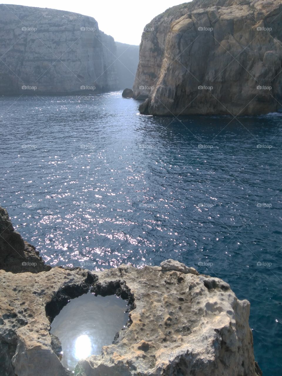 sheer cliffs of Gozo's Dwerja bay, home to blue window