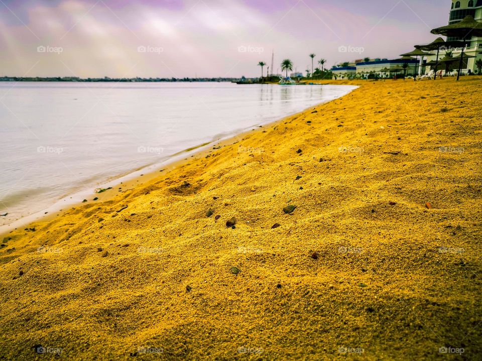 A sandy beach along the banks of the Suez Canal, Egypt.