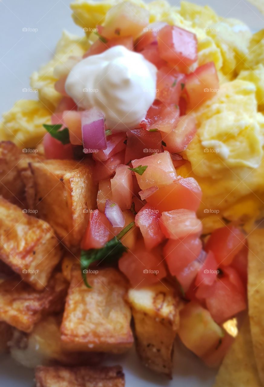 A delicious and tasty southwest eggs and potatoes come to life with some closeup photography.