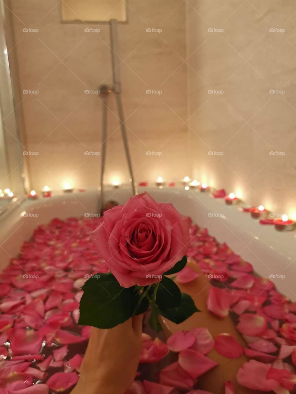 Bathroom. Rose petals in a bath. Woman relax and enjoy moments in a bath with roses petals. My favorite place in the house is bathroom...