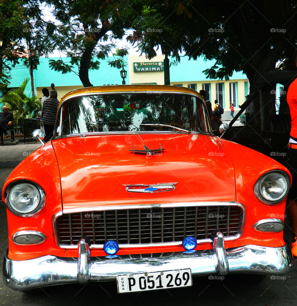 1955 Chevy in Cuba. Spotted this 1955 Orange and Gold Chevy parked on the street in downtown Santiago, Cuba! It is a sharp classic car!