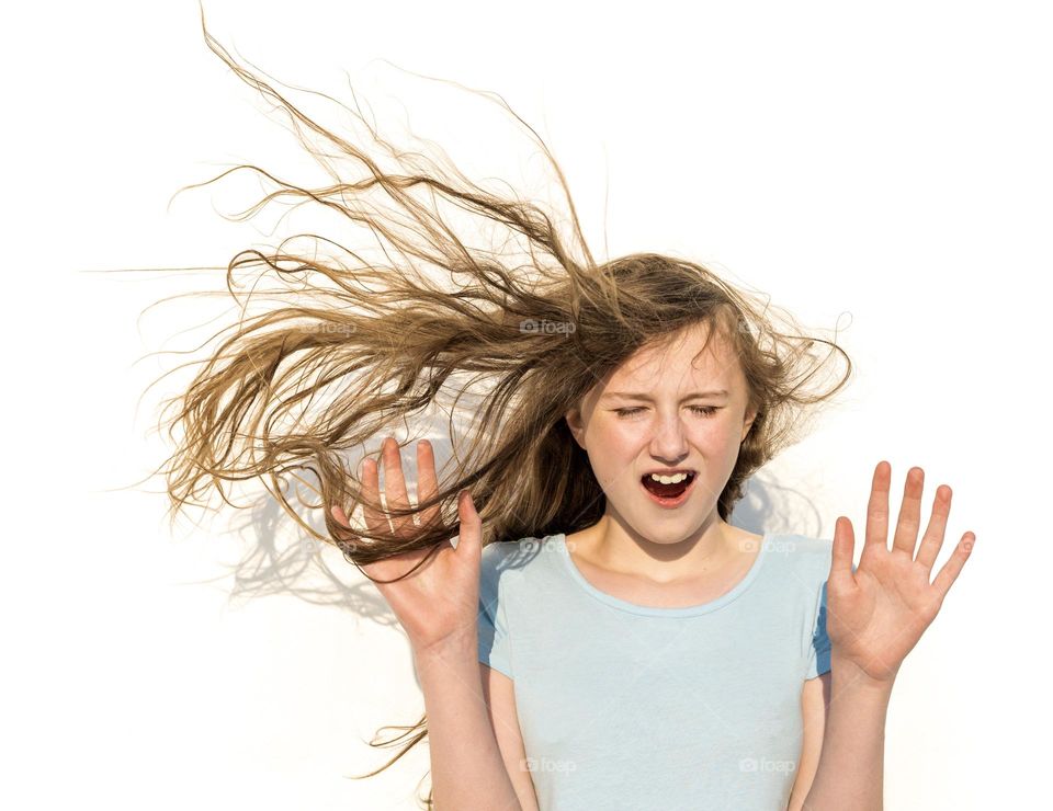 Girl caught by surprise as wind lifts hair
