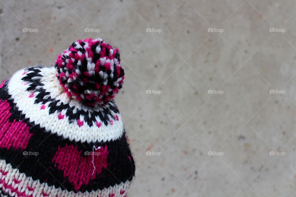 Girl with decorated hat on gray background