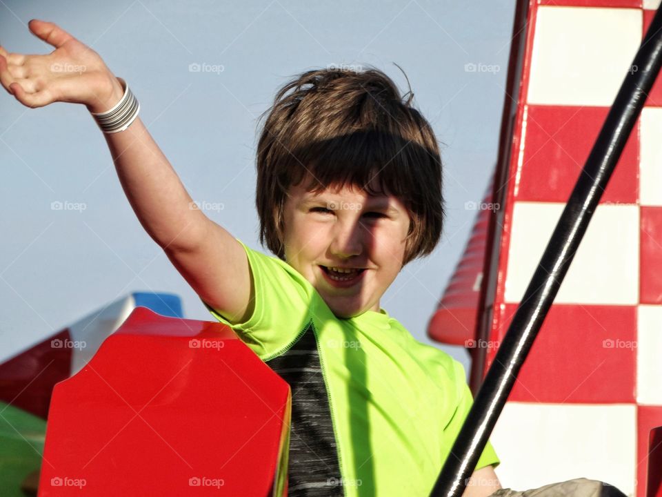 Young Boy At An Amusement Park