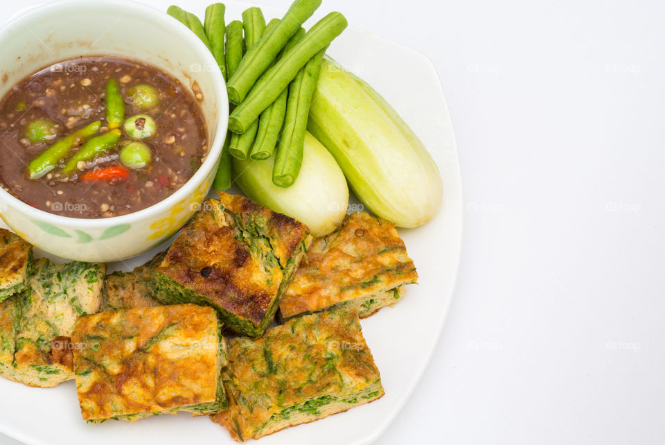 Fried acacia penata omelette or Cha-Om eggs with Chilli paste Thai style.