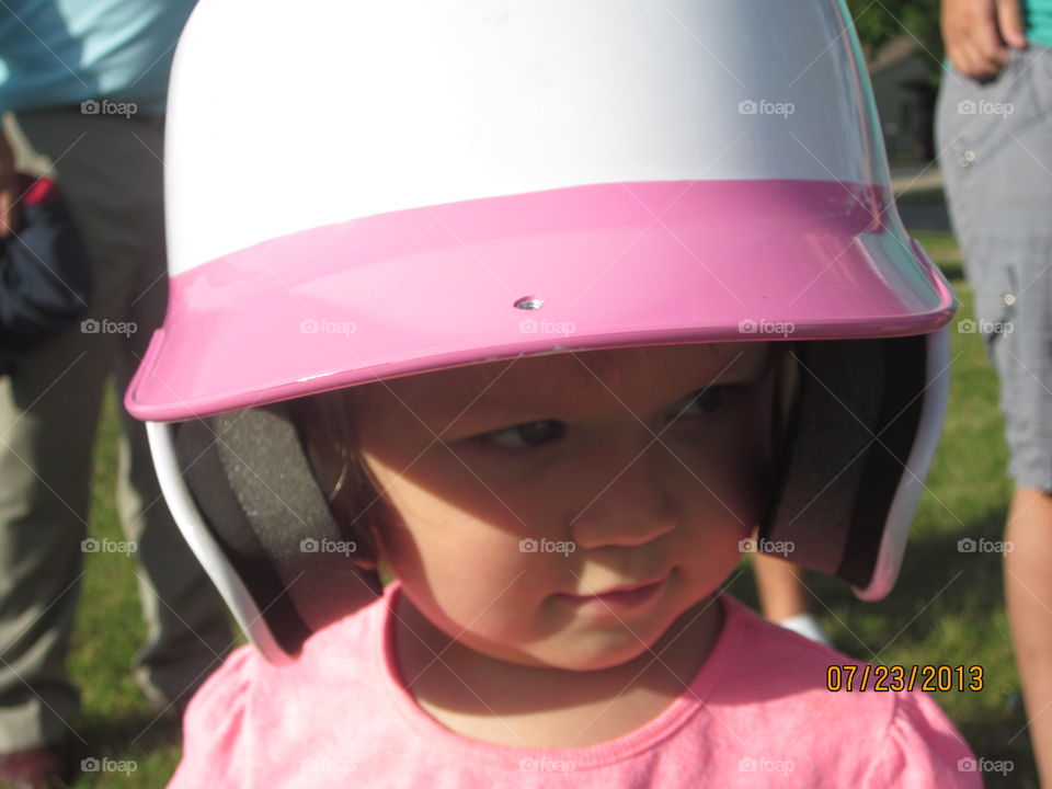 Close-up of little girl wearing helmet