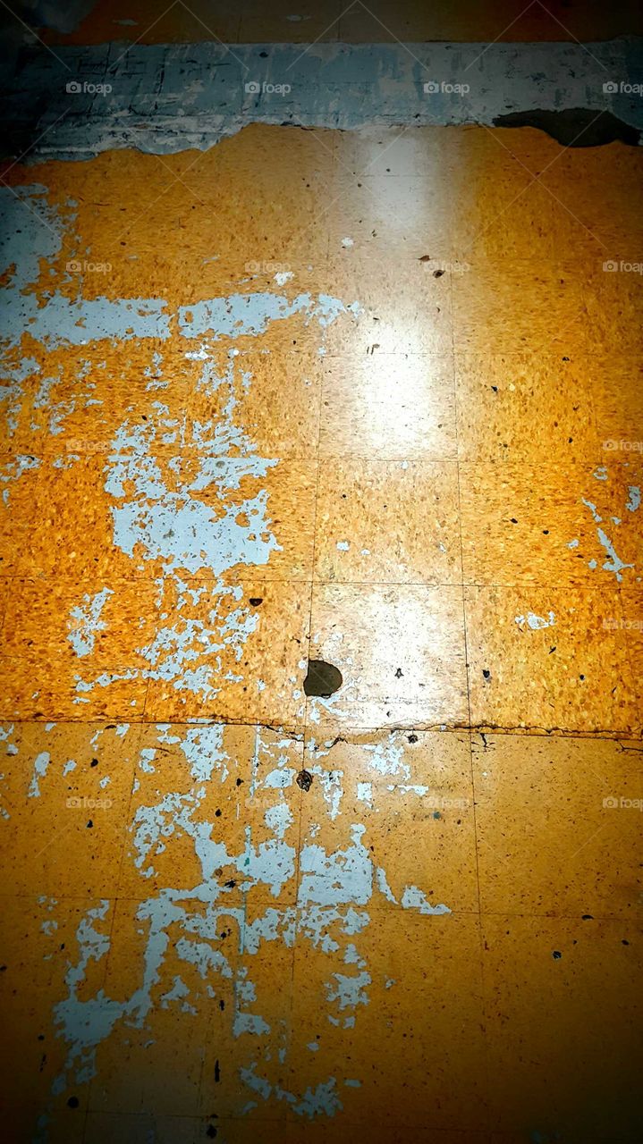 speckled paint stripped tile floor