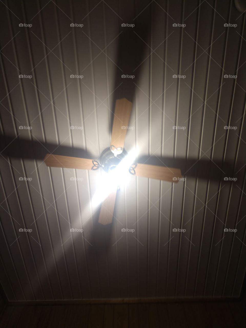Ceiling fan in AirBNB with the brightest light I've ever seen
