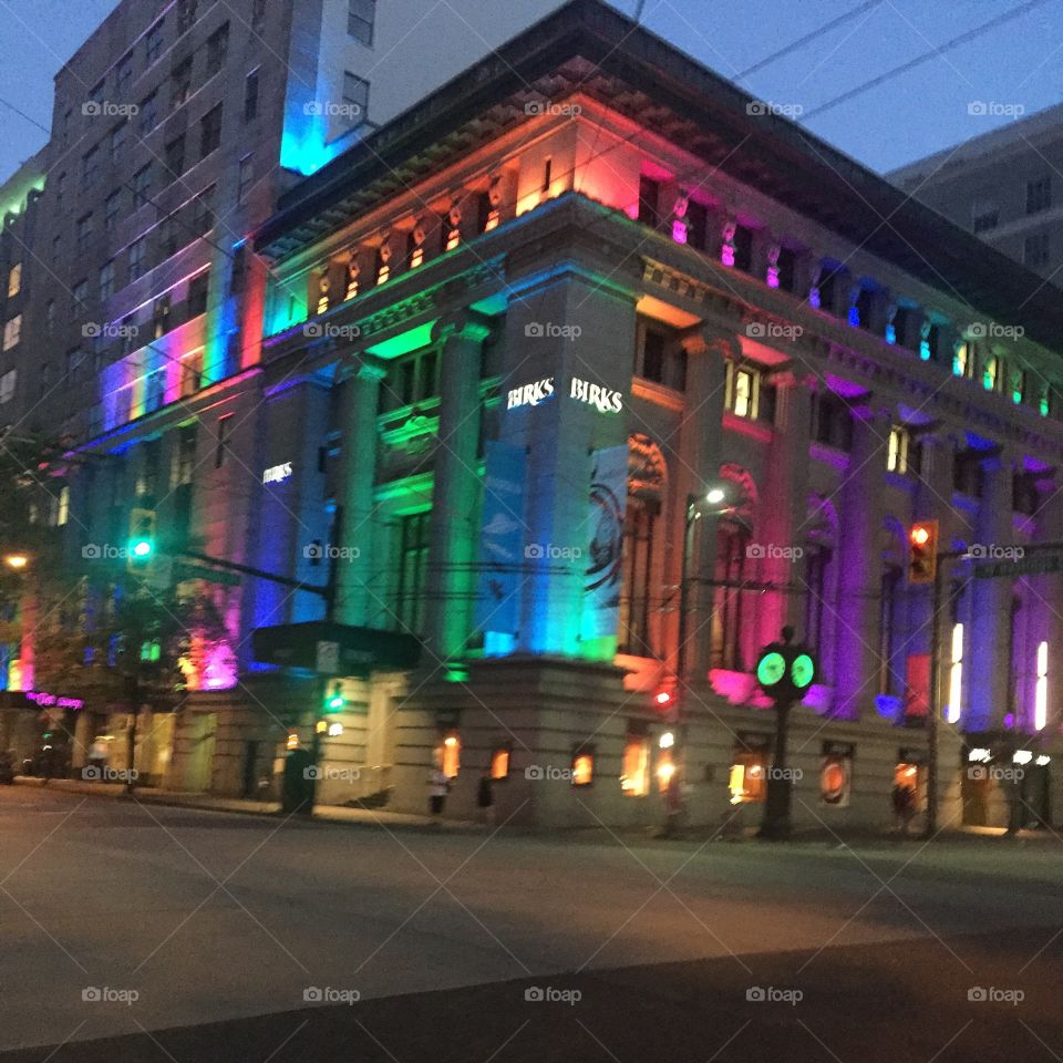 A building in Vancouver, B.C. is lit up in pride colours during Pride week.