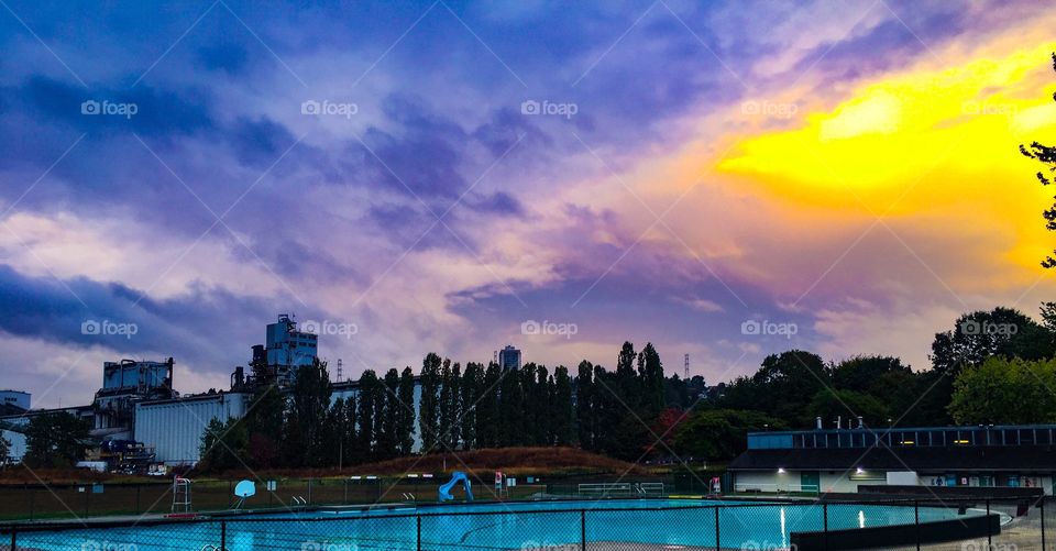 Altered eastern view of the sun setting over Burnaby, British Columbia from Brighton Park