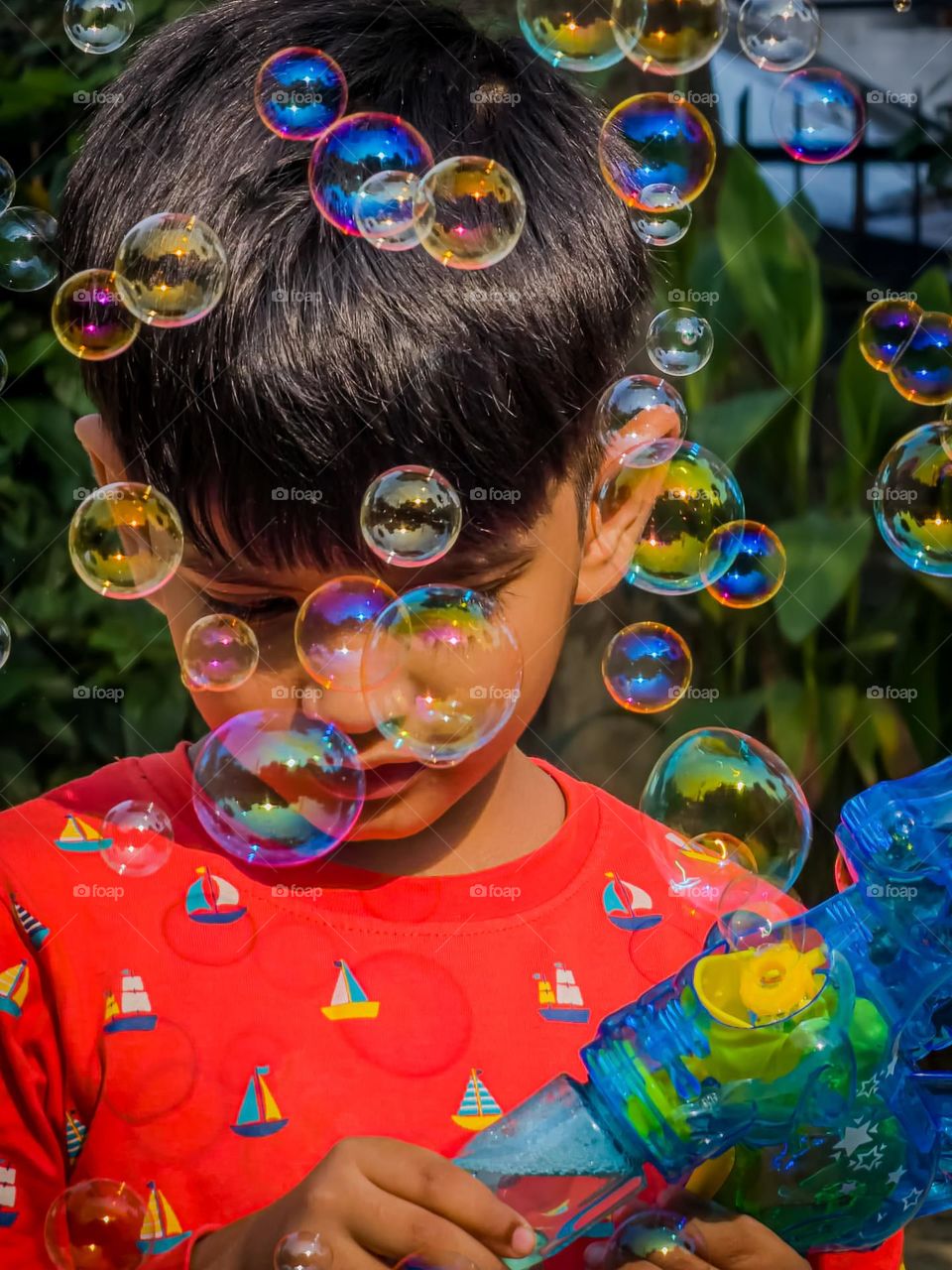 Kid playing with bubble gun