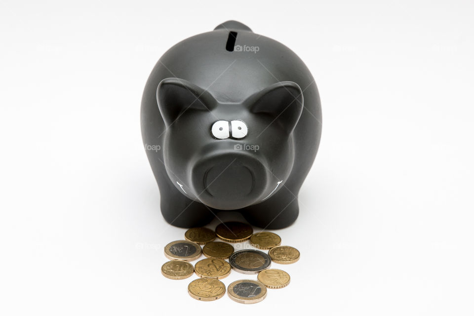 Black Piggy Bank With Coins, Isolated In White Backgound
