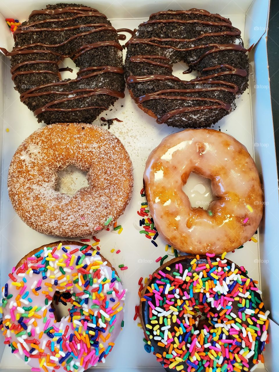 Assortment of half a dozen delicious donuts.