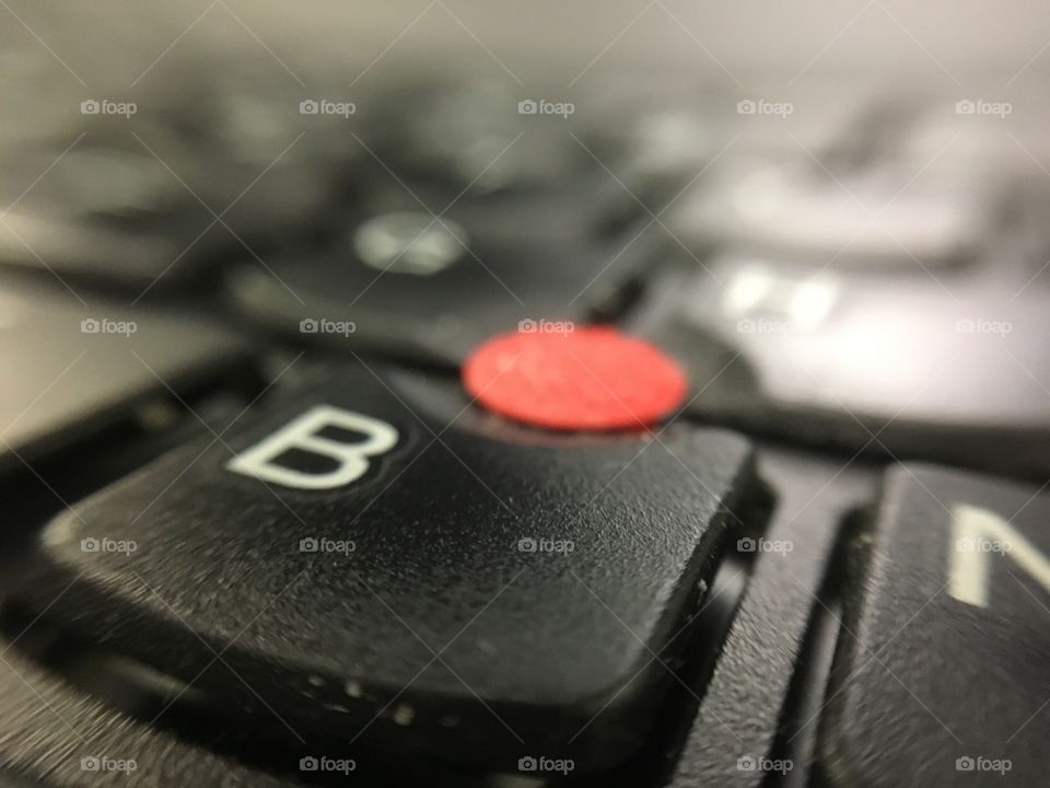 laptop keyboard with red button
