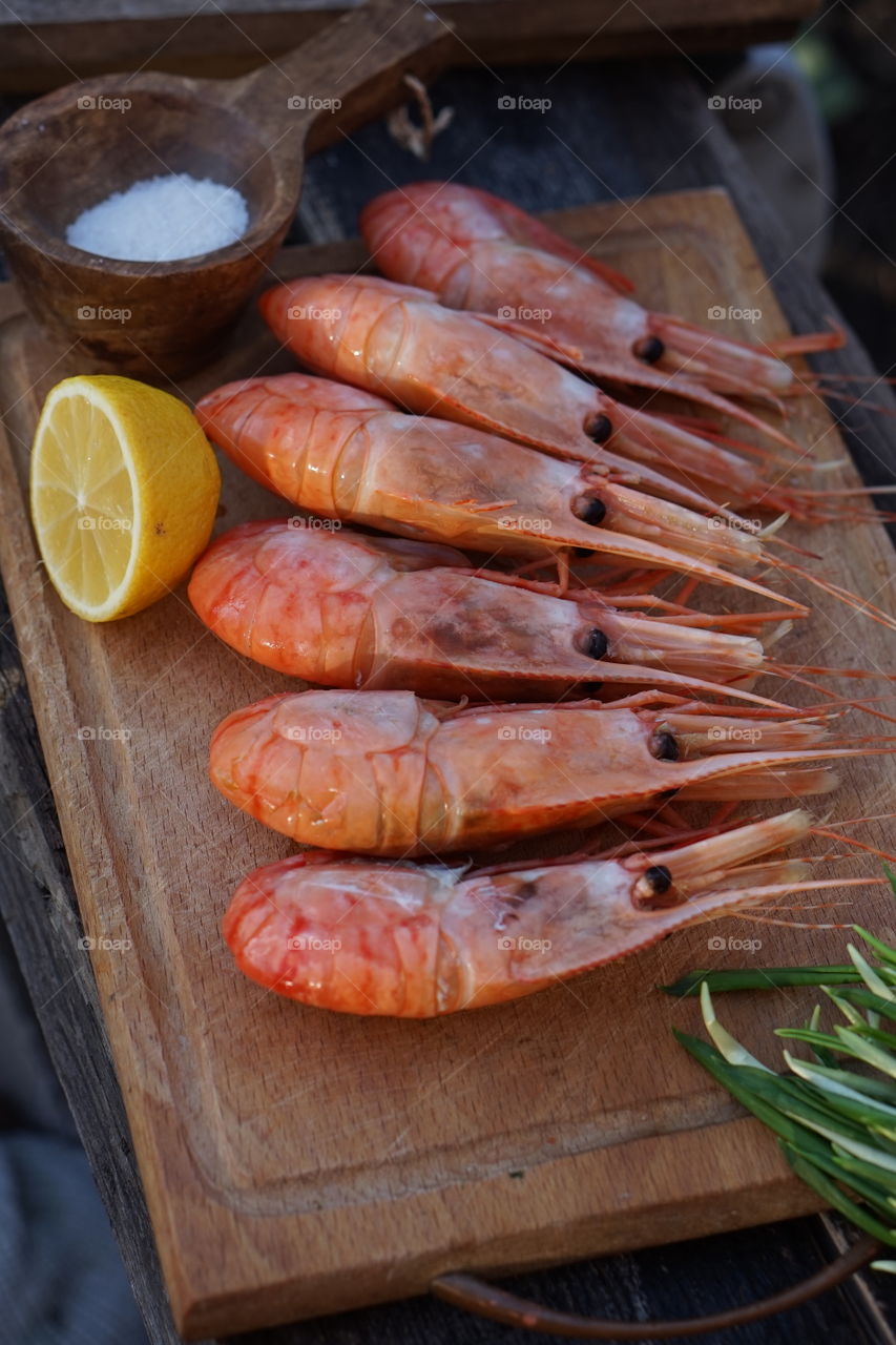 Shrimps on wooden board