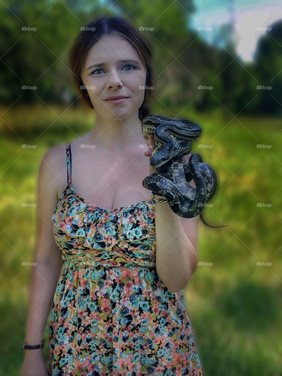 Portrait of a woman carrying snake