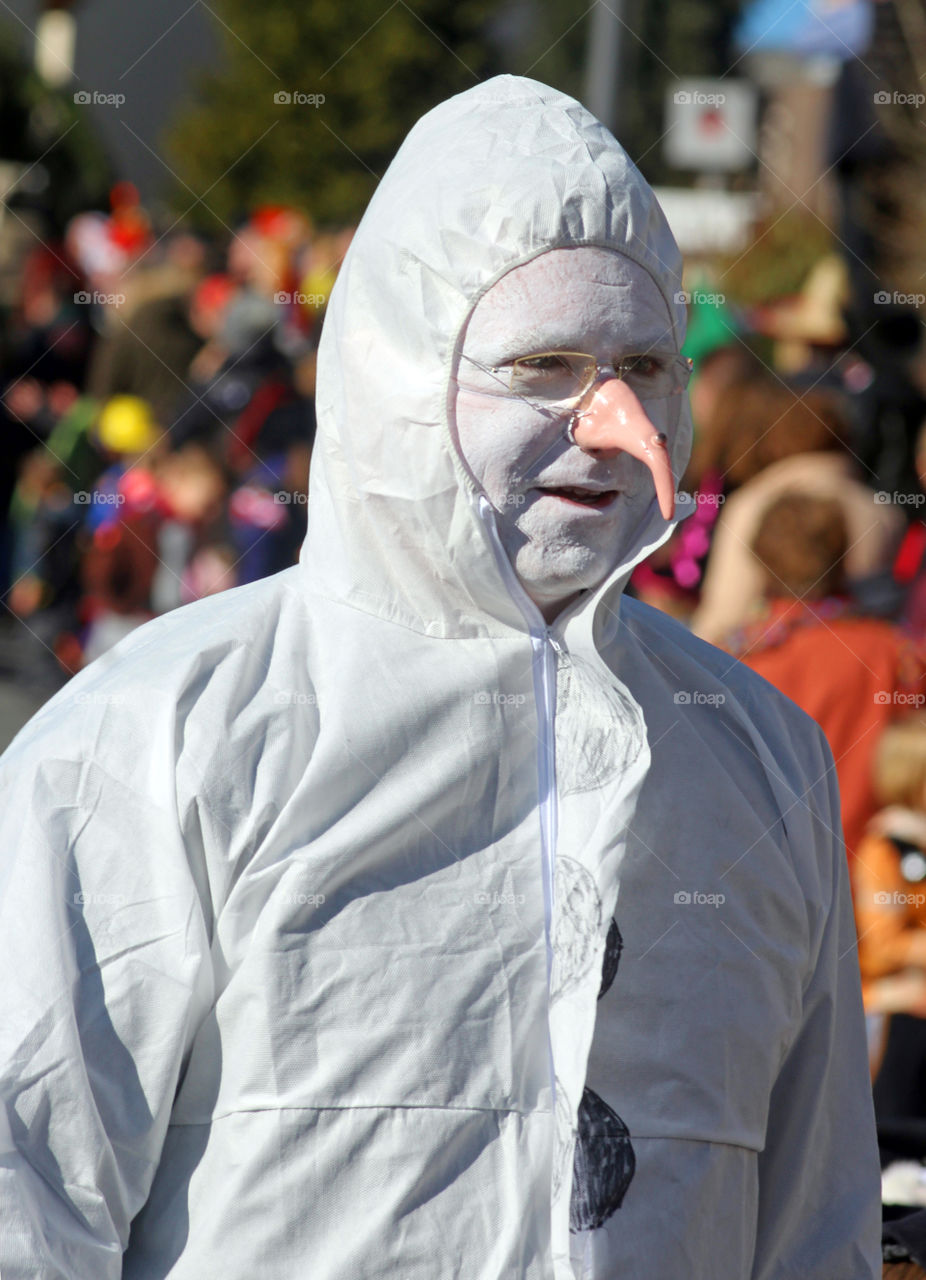 man in a snowman costume in a carnival procession