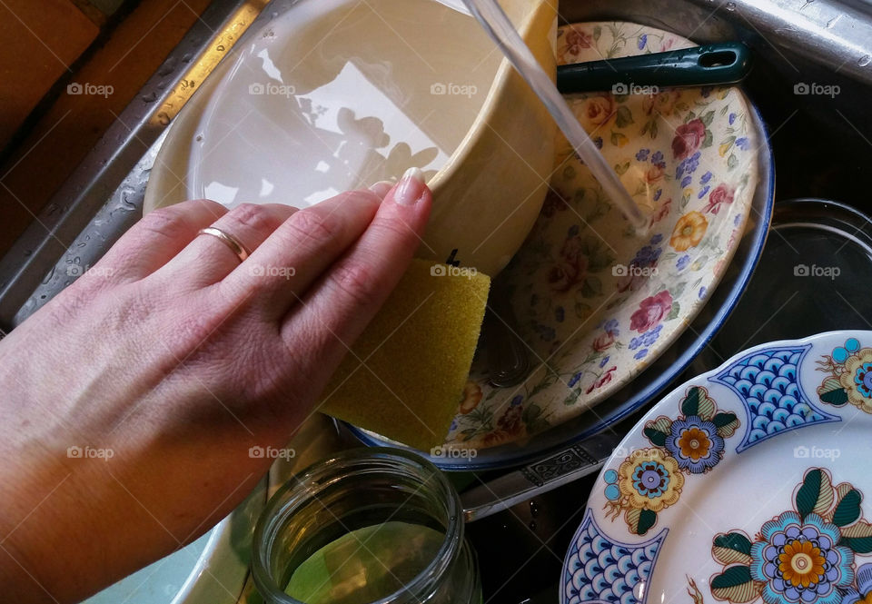 Washing the dishes in a kitchen sink