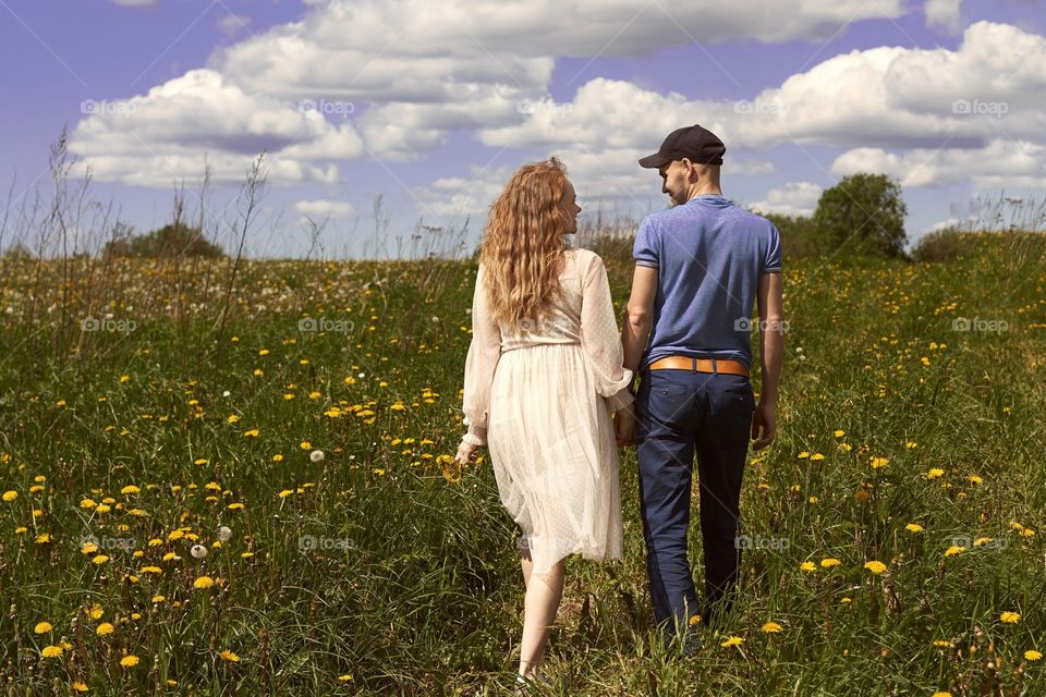 couple walks in the field